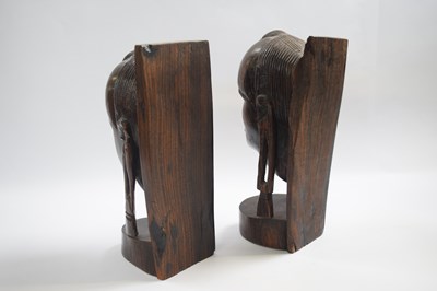 Lot 255 - Two wooden African carved heads modelled as...