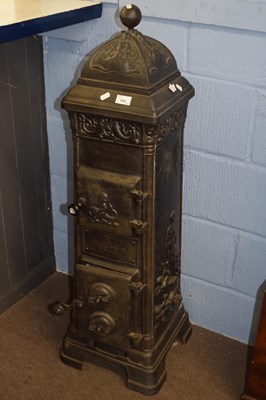 Lot 604 - Tall continental cast iron stove decorated...