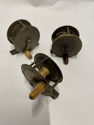 Lot 425 - Three vintage metal fishing reels, two with...