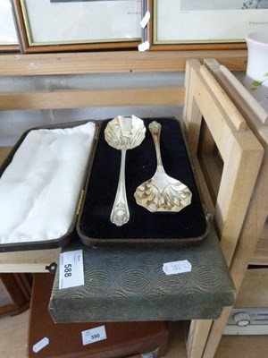 Lot 588 - A cased pair of silver plated serving spoons...