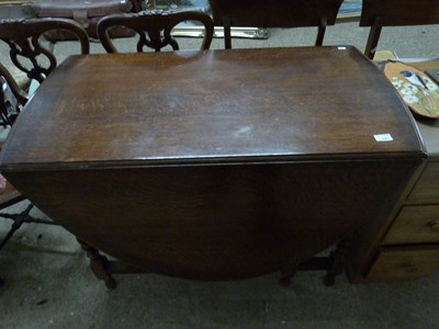 Lot 339 - Early 20th Century oak drop leaf dining table...