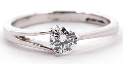 Lot 16 - A solitaire diamond ring, a three claw set...