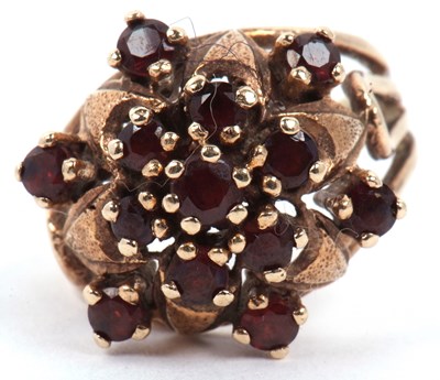 Lot 29 - Garnet set cluster dress ring raised between...