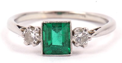 Lot 54 - Precious metal emerald and diamond ring, the...