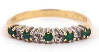 Lot 100 - A modern emerald and diamond half hoop ring,...