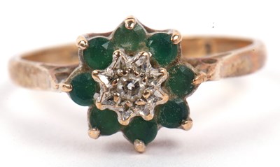 Lot 115 - A 9ct gold diamond and emerald cluster ring...