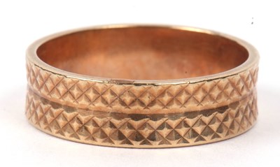 Lot 147 - A 9ct gold wedding ring, a textured design and...