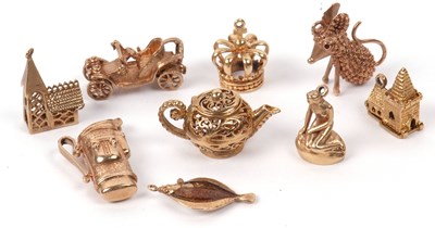 Lot 186 - A group of eight 9ct gold charms to include a...