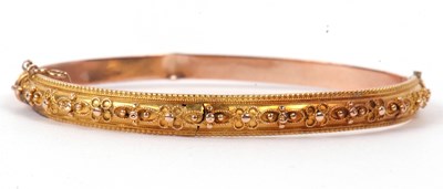 Lot 201 - A yellow metal hinged bracelet, the top...