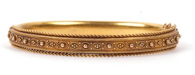 Lot 204 - A Victorian gold hinged bracelet, the top...