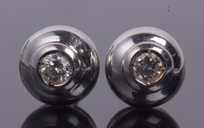 Lot 233 - A pair of diamond set earrings featuring a...