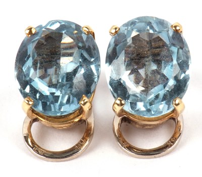 Lot 236 - A pair of blue topaz earrings, claw set in...