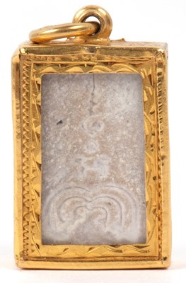 Lot 246 - A carved stone religious pendant depicting a...