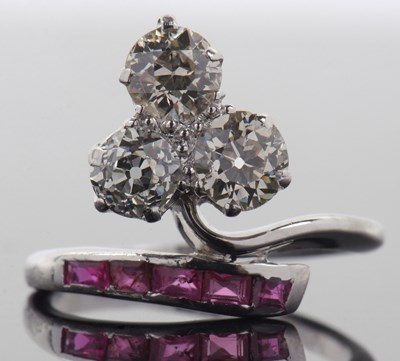 Lot 395 - A diamond and ruby ring, the trefoil set three...