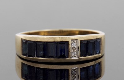 Lot 71A - An 18ct sapphire and diamond ring, the channel...