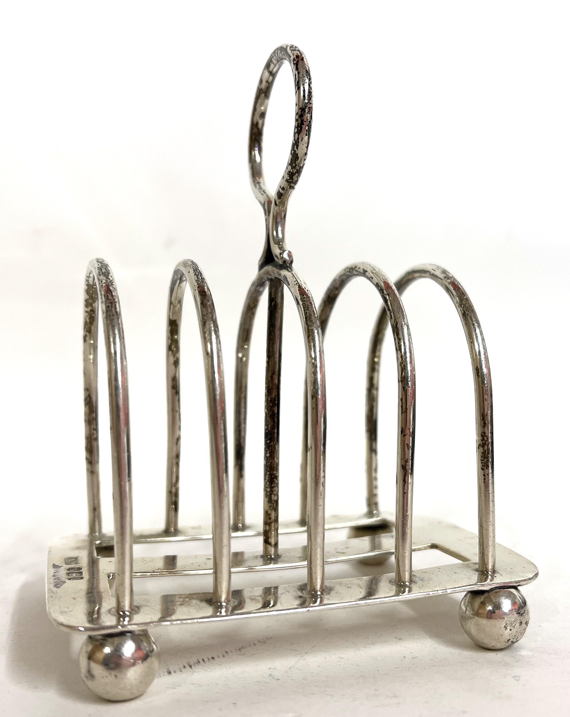 Lot 5 - An Edwardian silver toast rack of four
