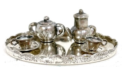 Lot 94 - A miniature white metal tea set comprising an...