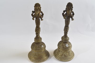 Lot 300 - Two brass table or temple bells decorated with...