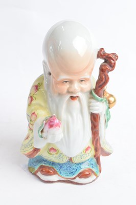 Lot 306 - Chinese porcelain figure of a deity decorated...