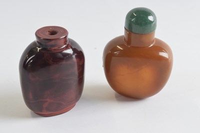 Lot 310 - Two further snuff bottles glass with a mottled...