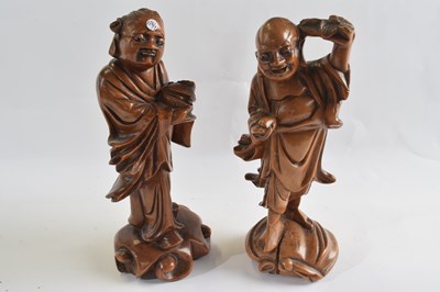 Lot 321 - Two carved wooden models of Holti, 21cm high