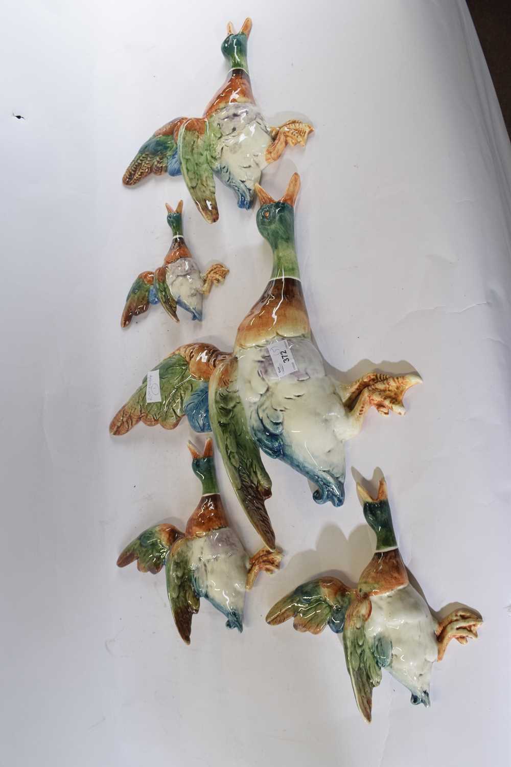 Lot 372 - A collection of pottery flying ducks, the...