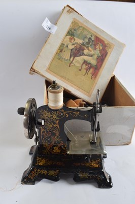 Lot 376 - A childs German sewing machine with painted...