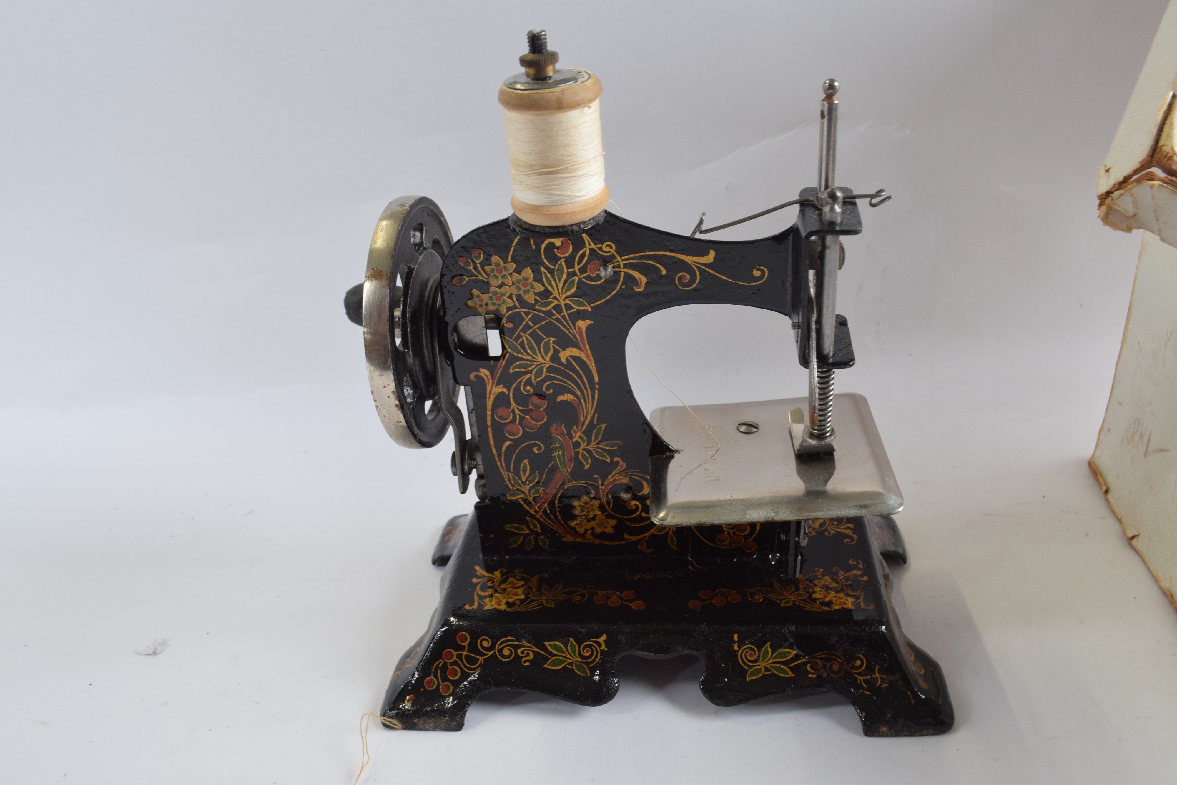 Lot 376 A childs German sewing machine with painted
