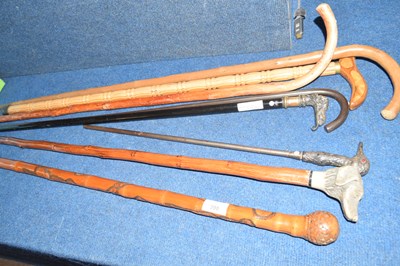 Lot 398 - Collection of walking sticks, some with carved...