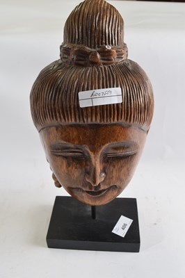 Lot 406 - A carved wooden head on black rectangular stand