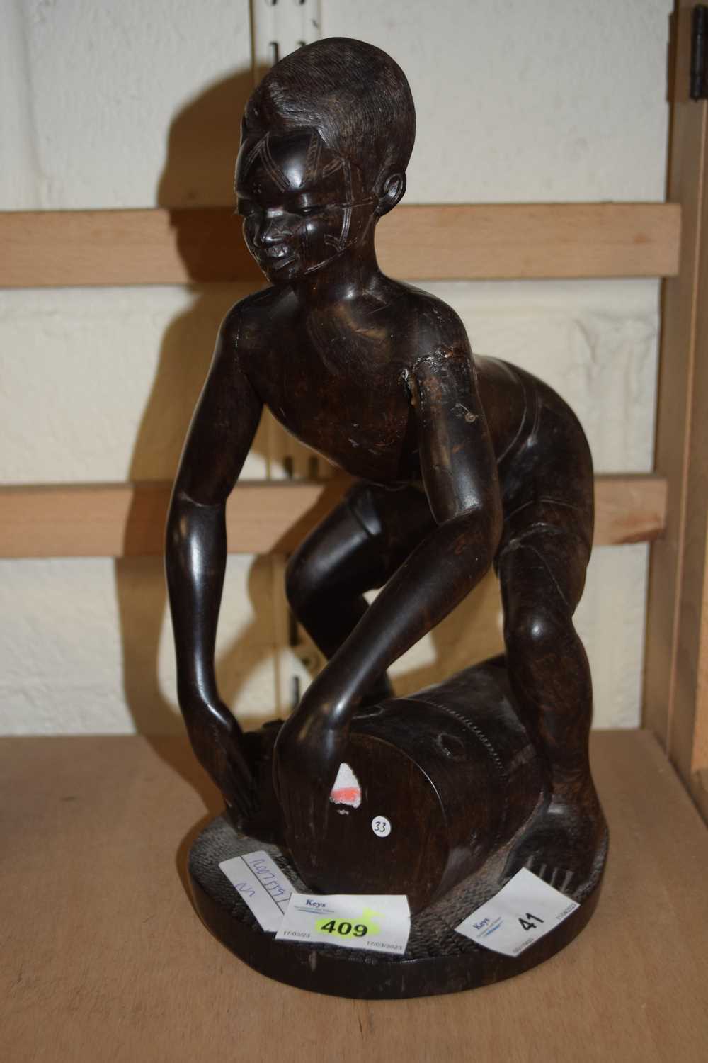 Lot 41 Carved African wooden figure of a drummer,