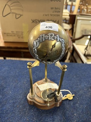 Lot 436 - A Art Deco style globe table clock raised on...