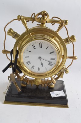 Lot 446 - A brass mantel clock shaped as a ships wheel,...