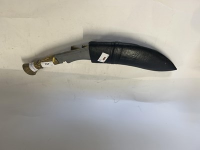 Lot 452 - Kukri knife with brass handle in leather...