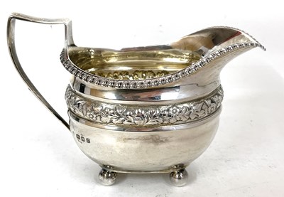 Lot 147 - A George V silver cream jug of oval form...