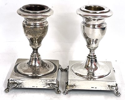 Lot 157 - A pair of white metal dwarf candlesticks of...