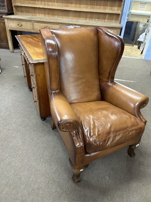 Lot 599 - A 20th Century brown leather upholstered wing...