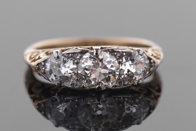 Lot 376 - A three stone diamond ring, the three round...