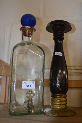 Lot 513 - Glass water syphon and a candlestick