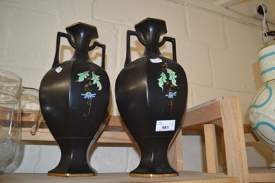 Lot 581 - A pair of black and floral decorated vases