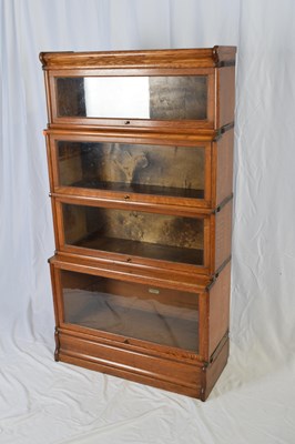 Lot 267 - Globe Wernicke, a four tier oak stacking...