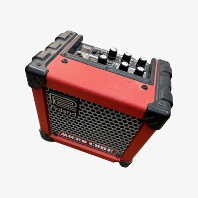 Lot 263 - A Roland Micro Cube practice guitar amp in red