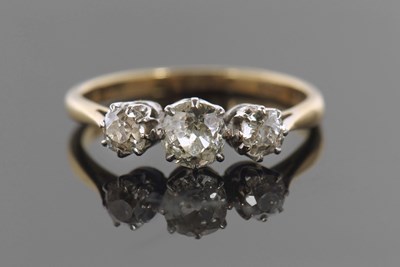 Lot 390 - An 18ct three stone diamond ring, the three...