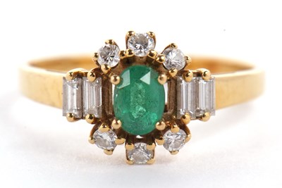 Lot 6 - An 18ct emerald and diamond ring, the central...