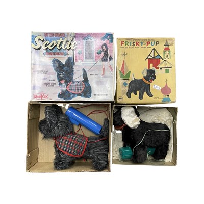 Lot 395 - A pair of vintage boxed battery operated toys,...