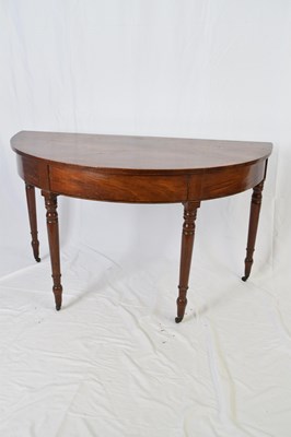 Lot 317 - Georgian mahogany demi-lune hall table raised...