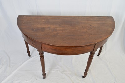 Lot 317 - Georgian mahogany demi-lune hall table raised...