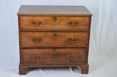 Lot 328 - George III oak chest of three drawers with...