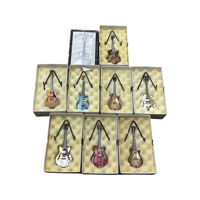 Lot 270 - A collection of boxed miniature guitar models...