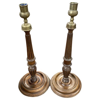 Lot 411 - A pair of turned oak candlesticks with metal...